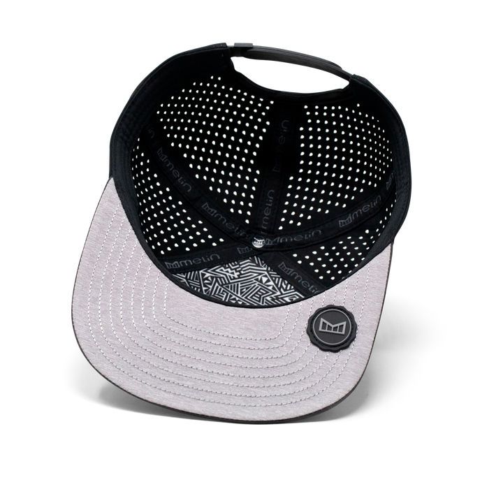 Black and gray baseball cap with mesh back on a white background