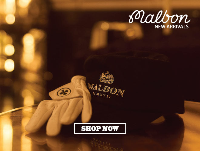 Golf glove and cap with Malbon logo on a wooden surface, blurred background