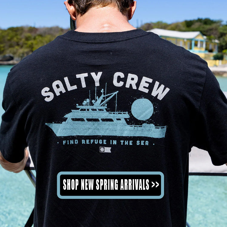Person wearing a black 'Salty Crew' t-shirt with a graphic of a boat and text.